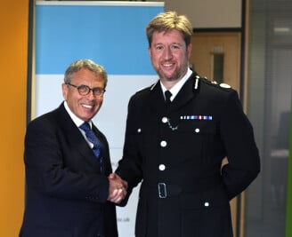 Former PCC Lorne Green shaking hands with former Chief Constable Simon Bailey