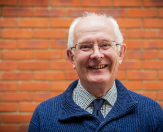 PCC Giles Orpen Smillie in jumper smiling