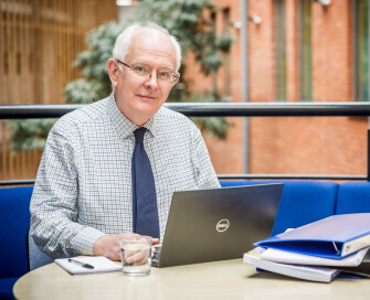 PCC Giles sitting at laptop