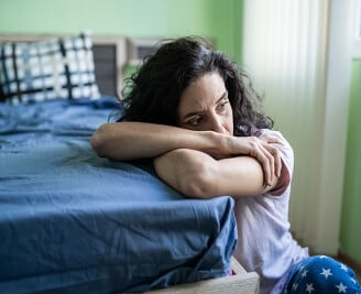 Woman resting her head on her arms