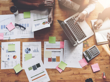 Birds eye view of people working around a table top